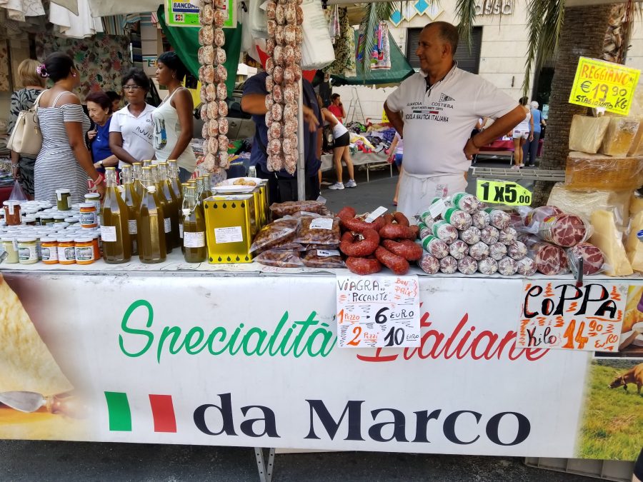 Banco di mercato italiano con alimentari e cartelli dei prezzi