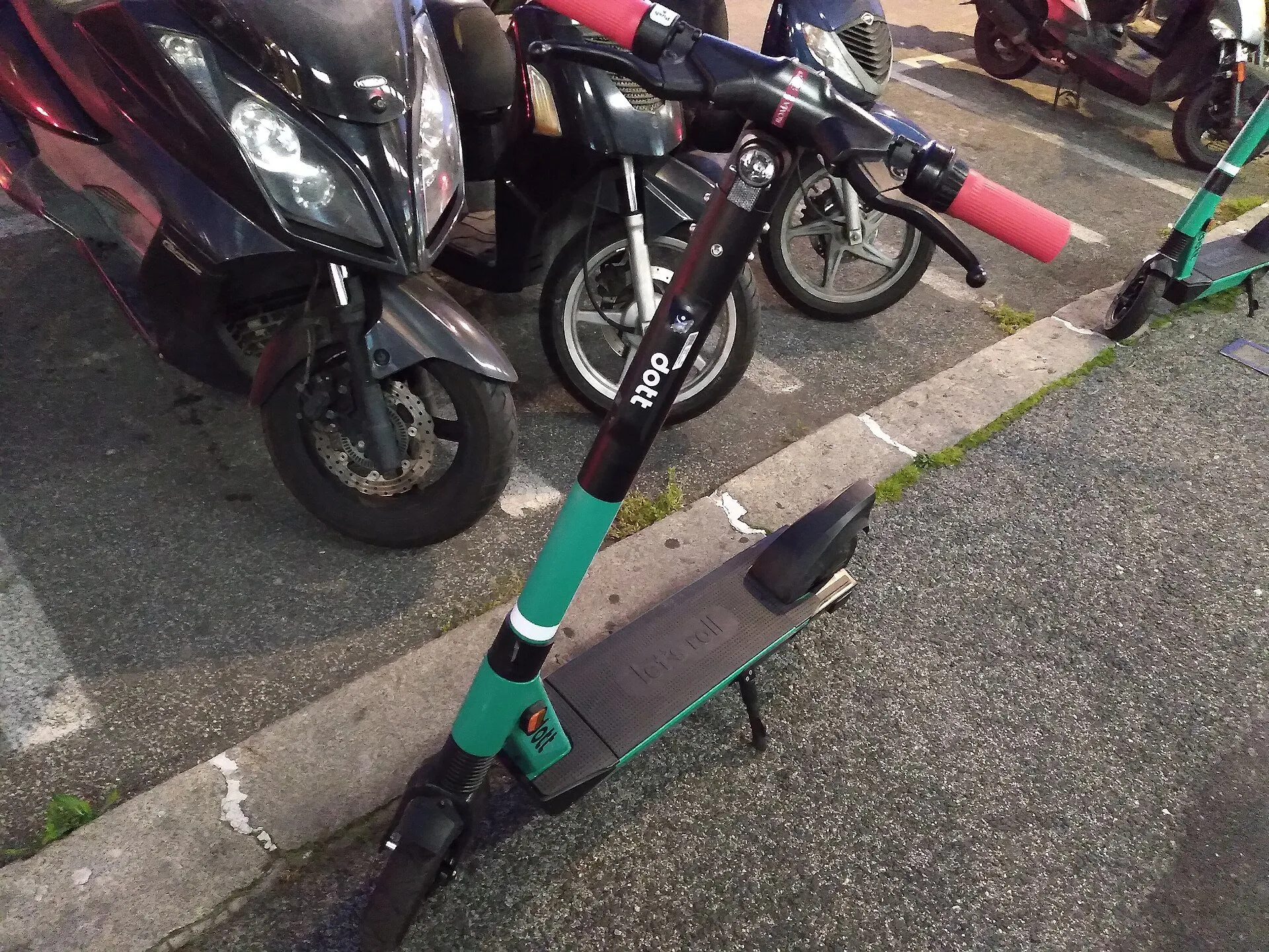 Monopattino elettrico parcheggiato vicino al marciapiede