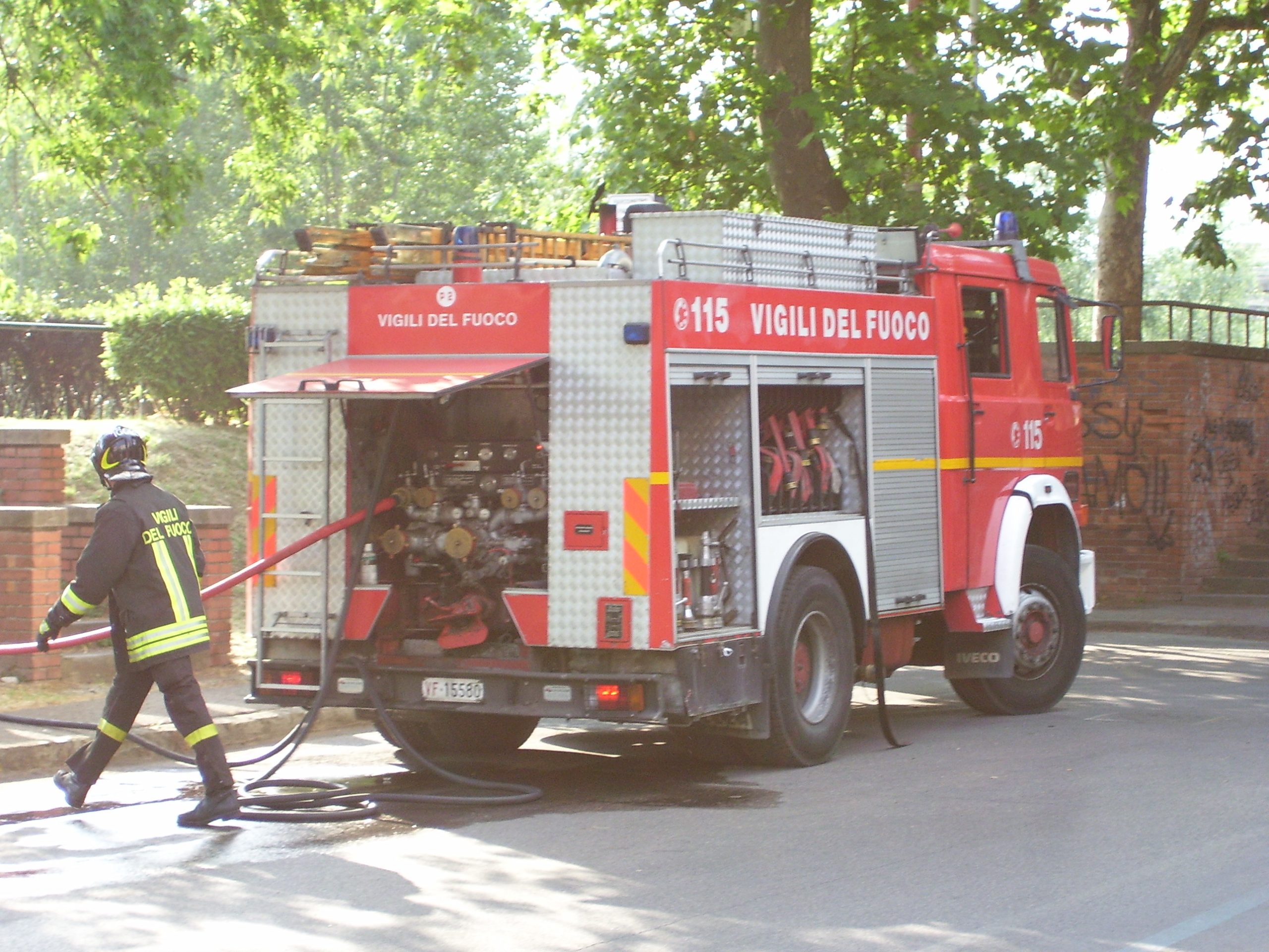 Autopompa dei Vigili del Fuoco con vigile e manichette